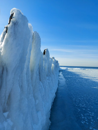 The Baltic Sea in Latvia in winter. The coastline is covered with piles of ice and snow. frozen seaの写真素材