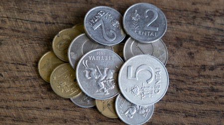 Various old Lithuanian coins isolated on wooden background.