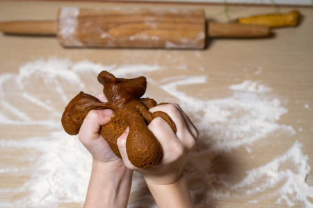 Gingerbread dough in the hands of a child. delicious Christmas cookies