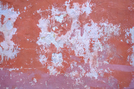 The outer surface of the wall of an old building with peeling off plaster. Abstract background. The...