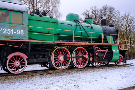 Old steam locomotive wheel and connecting rods. Tie rod or side rod for drive wheels. A retro...