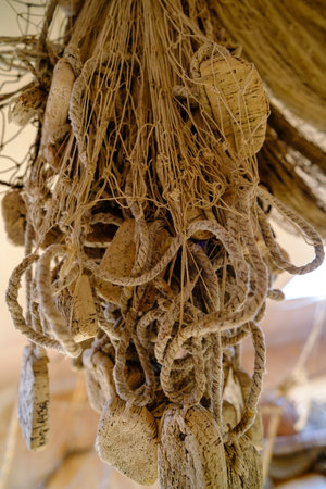 An old woven fishing net is hung to dry. Kihnu Island fishermens fishing gear. Estoniaの写真素材