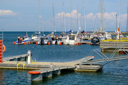 Kihnu, Estonia - June 23, 2023: The territory of a small port on the island of Kihnu. Docks for small ships.のeditorial素材