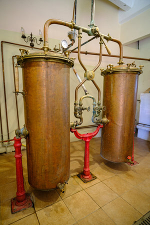 Pakruojis, Lithuania. July 7 , 2023: Industrial equipment for the production of alcohol. Copper is still alembic in the still for making spirits. soft focus.のeditorial素材