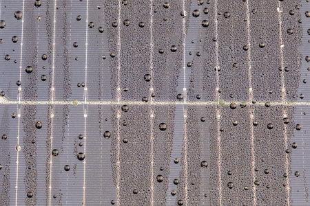 Solar panel with raindrops on nano coating. Renewable energy from the sun, green energy, concept Generate energy. View of the panels from the front.の写真素材