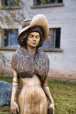 Valga, Estonia - October 22, 2023: Public bus waiting stops. Wooden sculpture. Woman silhouette, profileのeditorial素材