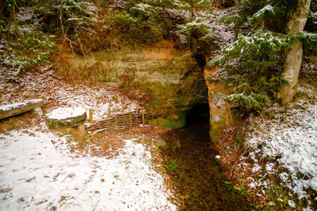 The water flows from a small cave opening, forming a natural spring. Skanaiskalns nature park....
