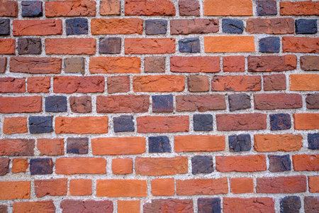 red brick wall wall brick structure. an old wall in a historical part of the city.