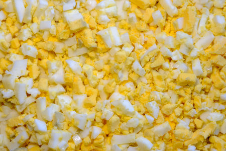 cut the chicken egg into small cubes in large quantities. salad preparation.の写真素材
