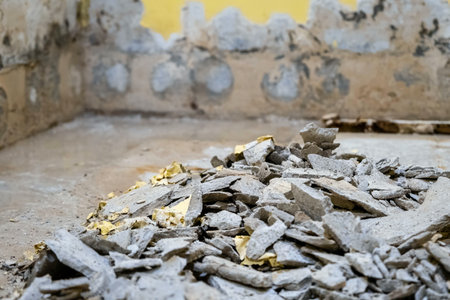A room under renovation with debris of broken walls and plaster on the floor.の写真素材