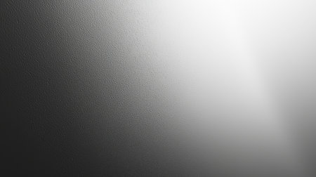 Abstract textured surface transitioning from dark to light with soft illumination, creating a neutral and minimalist aesthetic.の素材