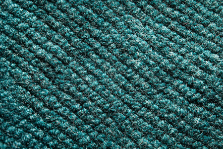 Detailed view of a teal woven carpet with a textured loop pattern, ideal for interior design, flooring visuals, or textile-focused projects.の素材