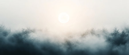 Ethereal landscape of a dense forest shrouded in mist, with a glowing sun softly illuminating the foggy, atmospheric scenery.の素材