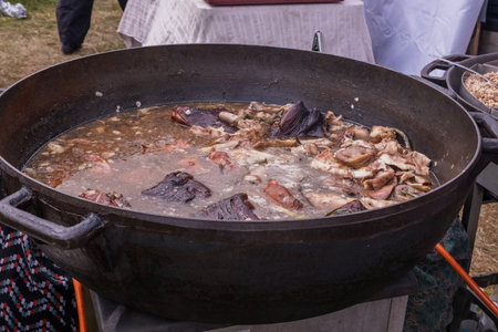 Traditional pork stew simmering in large cauldronの写真素材