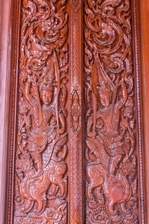 Carved wooden door in thai templeの写真素材