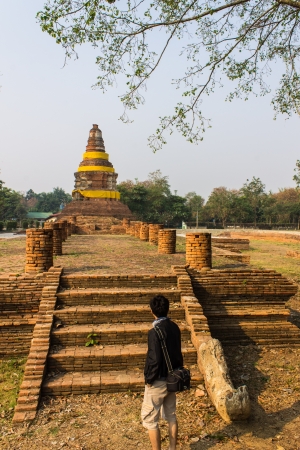 Traveler And Old Chedi in Wiang Kum Kam, Ancient Cityの写真素材