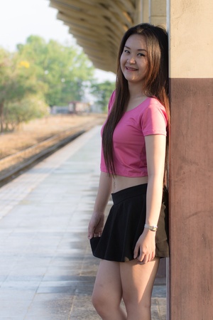 Portrait of a beautiful Thai woman smiling on train station platformの写真素材
