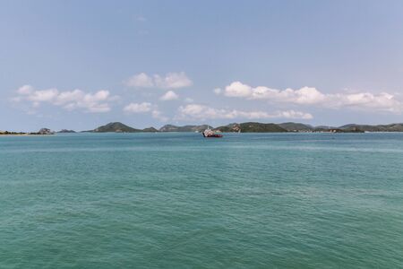 Sea landscape  The small towing ship in the sea against blue mountains , Rayong Thailandの写真素材