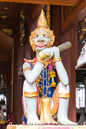 Thai giant statue with teak chapelの写真素材