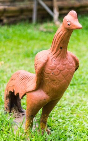 Thai chickens statue on grassの写真素材