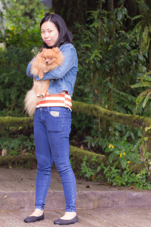 Asian woman and a pomeranianの写真素材