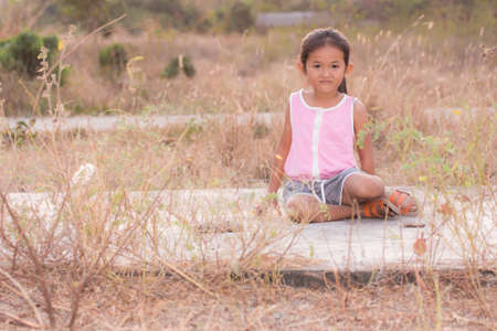 Portrait thai girl in dry grassの写真素材