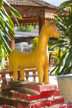 Golden horse statue in thai templeの写真素材