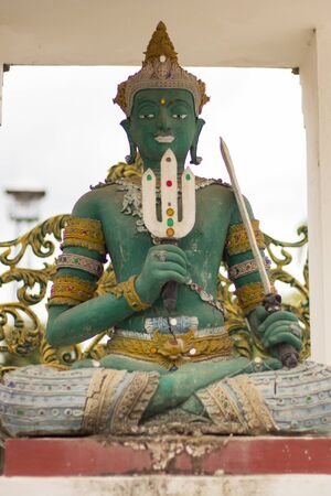 Green God Indra statue in Thai templeの写真素材