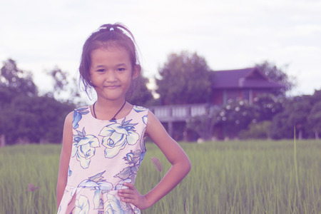 asian children girl in green rice filedの写真素材