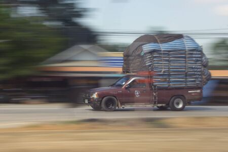 pick-up truck Speeding in road, panning camera, Thailand asiaの写真素材