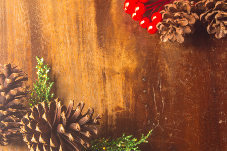 Pine cones red  bead pine needles on wood christmas still life backgroundの写真素材