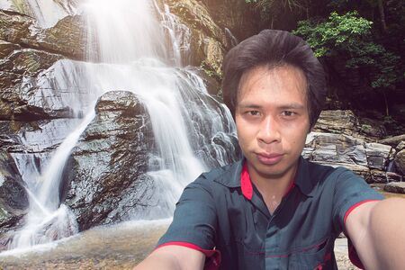 Asian Man Selfie at Tad Mork Waterfall in Maerim Chiang Mai Thailandの写真素材