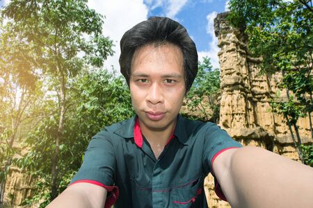 Asian man with Selfie phachor in Doi Lo  Chiangmai , Grand Canyon National Park, Thailandの写真素材
