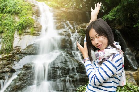 Asian woman at Tad Mork Waterfall in Maerim Chiang Mai Thailandの写真素材