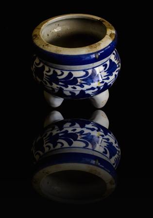 Old incense burner Ceramic isolated on black with reflectionの写真素材