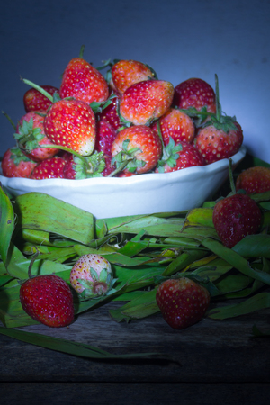 Fresh Strawberry in cup on banana leaf still lifeの写真素材
