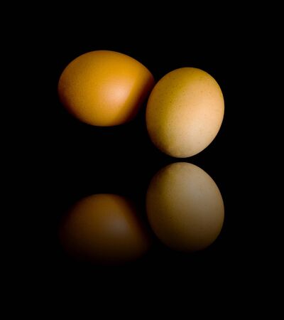 two Egg Isolated on black with reflectionの写真素材
