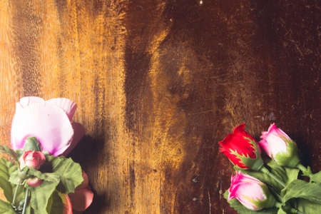 Plastic rose on  wooden background valentineの写真素材
