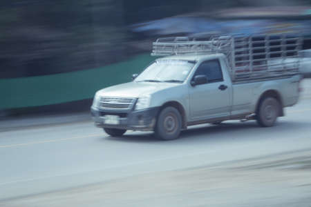 pick-up truck Speeding in road, panning camera, Thailand asiaの写真素材