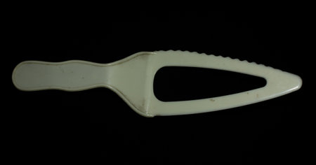 plastic cake knife isolated on black backgroundの写真素材