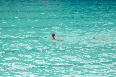 Asian child swimmer in the swimming pool