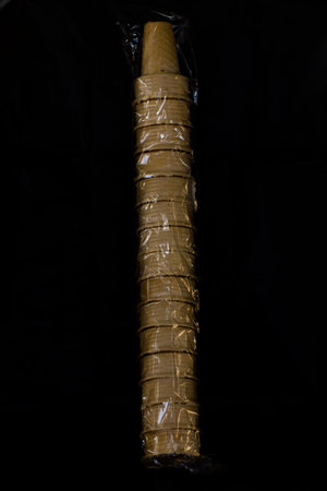 Ice cream cone row in plastic Isolated on black backgroundの写真素材