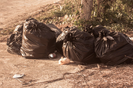 household black garbage bags on floorの写真素材