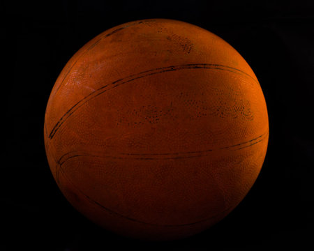 Old basketball Isolated on black backgroundの写真素材