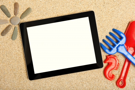 Tablet in the sand for children toysの写真素材