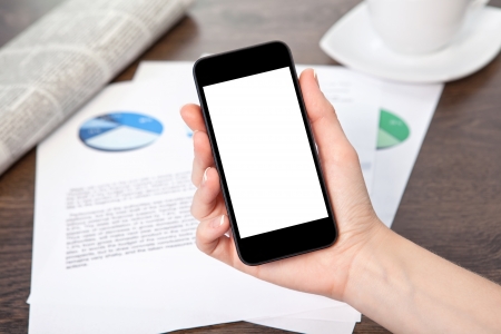 woman hand holding a touch phone with isolated screen on the table with graphicsの写真素材