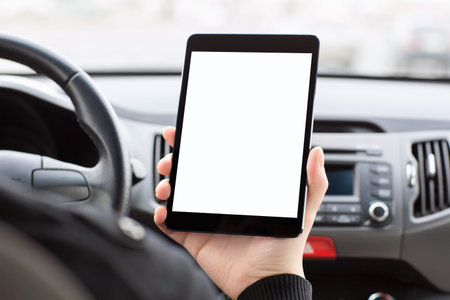 man sitting in the car and holding a touch tablet with isolated screen 