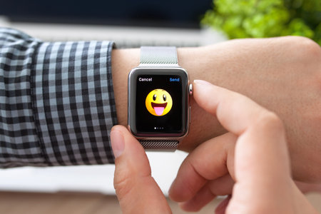 Alushta, Russia - August 11, 2015: Man hand with Apple Watch and smile on a screen. Apple Watch was created and developed by the Apple inc.のeditorial素材