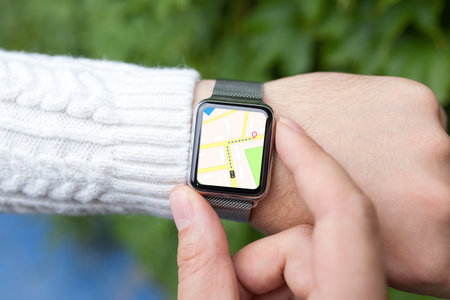 man hand and smart watch with map in the screen on the street
