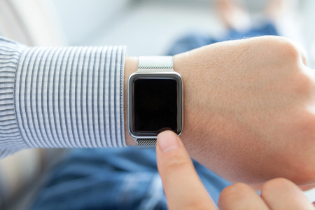 Man hands with smart watch and finger touching on the screenの写真素材
